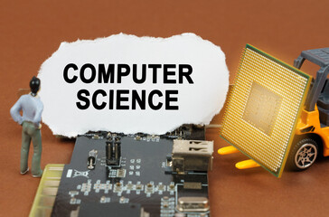 On the board with microcircuits lies a paper plate with the inscription - Computer Science