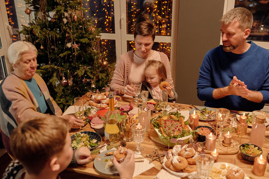 Horizontal portrait of close-knit family having festive dinner