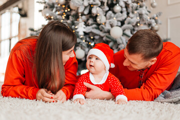 Happy family near the Christmas tree for the New Year