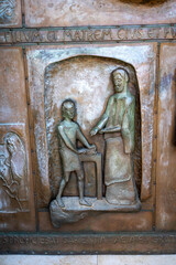 NAZARETH, ISRAEL December 2022: Iron door with bas-reliefs with biblical motifs of the Basilica of the Annunciation in Nazareth, Israel