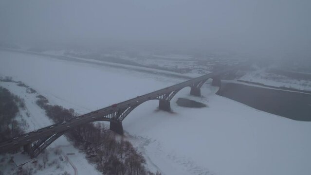 Aerial photography of a road bridge over the river in winter