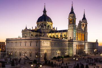 Fototapeta na wymiar Madrid, Spain 28-12-2022 The Almudena Cathedral during a colorful sunset, it is the most important and Catholic religious building in Madrid and a visit is free of charge except for the crypt 