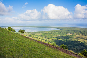 Fototapeta na wymiar View of the coastline of the Atlantic Ocean on the island of Haiti. Green coastline turns into ocean