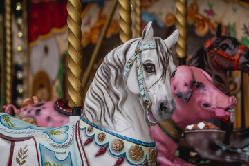 Fototapeta na wymiar carousel white horse portrait with foreground 