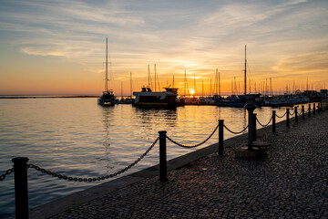 Beautiful colourful sunset at Olhao, Portugal with boat silhouettes
