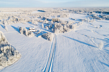 Fototapeta na wymiar An aerial view of a frosty rural landscape on a winter day in Estonia, Northern Europe