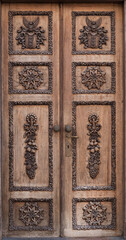 Medieval door with fine wooden symbols and carvings. Beautiful historic wooden door from old town of Tallinn, Estonia.