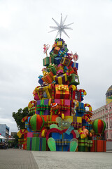 Public Christmas decoration in the theater square in the city of Manaus, Brazil. Christmas tree full of gift boxes, next to the tree the landmark of the city of Manaus, the theater.