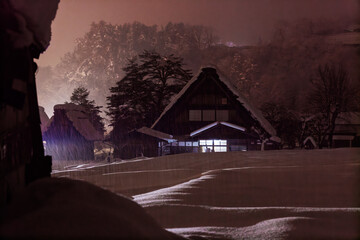 Traditional A-frame house in pink misty glow as snow falls in mountains - 557274548