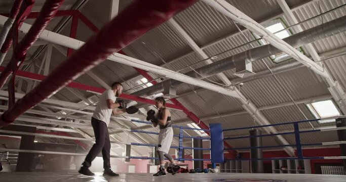 Sportswoman training with coach in gym