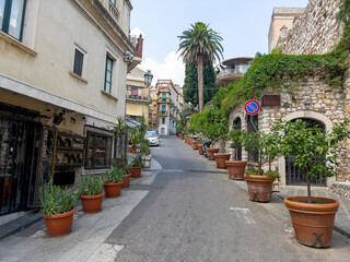 A street in Tahormina with flower pots.