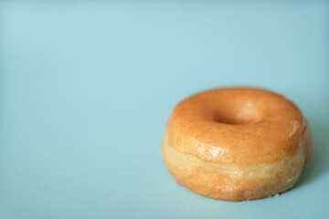 Glazed Donut on Light Blue Background