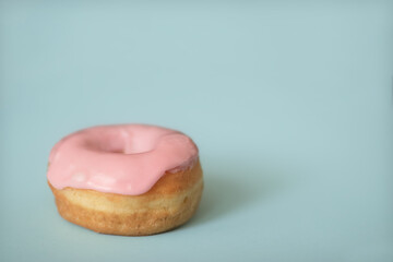 Pink Iced Donut on Light Blue Background
