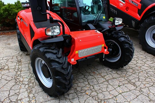 Front view of modern french compact agricultural telehandler vehicle Manitou MLT 625, red color, displayed on agro expo in Nitra, Slovakia.