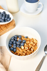 Homemade granola with nuts and fresh blueberries for breakfast. Healthy breakfast. Vegetarian food concept