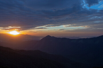 Obraz premium Sun rising over the clouds, in the hills. Immigrants highway, Santos, Sao Paulo state, Brazil