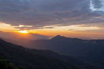 Sun rising over the clouds, in the hills. Immigrants highway, Santos, Sao Paulo state, Brazil