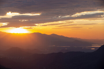 Sun rising over the clouds, in the hills. Immigrants highway, Santos, Sao Paulo state, Brazil