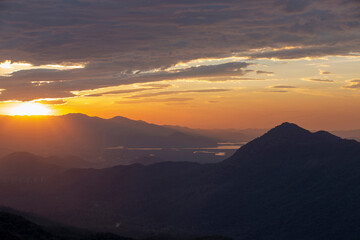 Sun rising over the clouds, in the hills. Immigrants highway, Santos, Sao Paulo state, Brazil