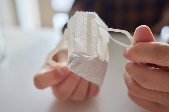 brewing process,a bag filled with boiling water for drip coffee in a cup,top view.
