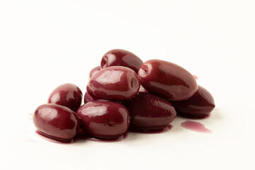 Focus on purple olives on white background.