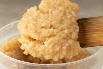 Garlic paste on wooden spatula. Selective focus.