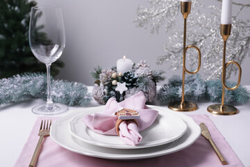 Stylish table setting with pink fabric napkin and festive decor on white background