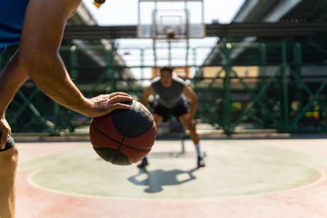 Stof per meter Two man athlete playing streetball match shooting and defense basketball on outdoors court together in sunny day. Sportsman do sport training basketball at street court under highway in the city. © CandyRetriever 