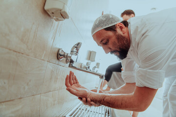 A Muslim performing ablution. Ritual religious cleansing of Muslims before performing prayer. The...