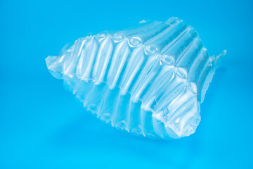 Plastic inflatable air shockproof packaging on blue background,Express protection concept