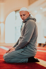 A Muslim praying in a modern mosque during the holy Muslim month of Ramadan