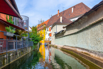 View of half timber homes and cafes from a boat on the Lauch canal in the historic medieval Petite...