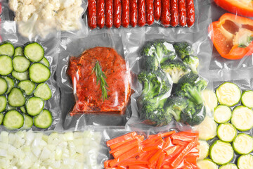 Many different food in vacuum packings on table, top view - obrazy, fototapety, plakaty