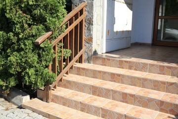 View of beautiful stone stairs with metal handrail near house outdoors