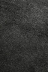 Texture of dark grey stone surface as background, closeup