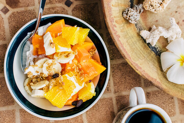 Coffee and breakfast bowl with yogurt and tropic fruits