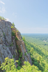 Aerial view of a mountain side with exposed rock and sweeping view of the valley