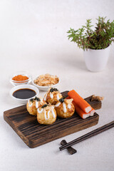 Takoyaki is Japanese Street Food containing with octopus, sausage or cheese. garnish with seaweed and katsuobushi