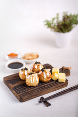 Takoyaki is Japanese Street Food containing with octopus, sausage or cheese. garnish with seaweed and katsuobushi