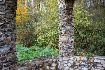Park gazebo with columns built of wild raw stone - flint and limestone