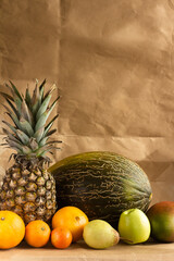 still life of tropical fruits on a light brown background