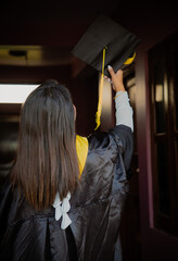 female graduate holding diploma