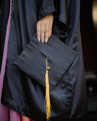 female graduate holding diploma