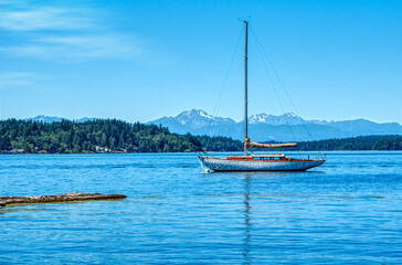 sailboat on the sea in a secluded harbor among mountains