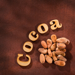 Organic cocoa beans - Theobroma cacao. Cocoa word in wooden letters