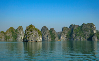 Fototapeta na wymiar Cat Ba, Vietnam - December 21, 2022: A fishing boats in Lan Ha Bay in Cat Ba, Vietnam.