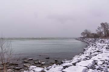 A winter snow storm pummels Sam Smith Park by Lake Ontario in Toronto, highlighting the bleakness of the season.