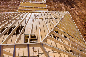 Installation of wooden roof beam over an already built stick home with use framework trusses