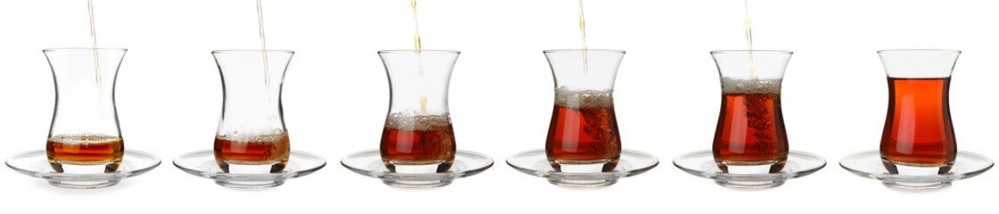 Process of pouring of tasty Turkish tea into glass cup on white background