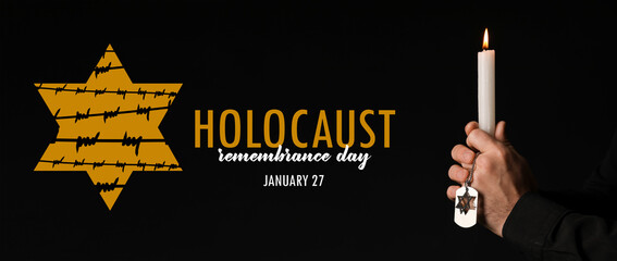 Banner for International Holocaust Remembrance Day with praying Jewish man holding candle on dark...